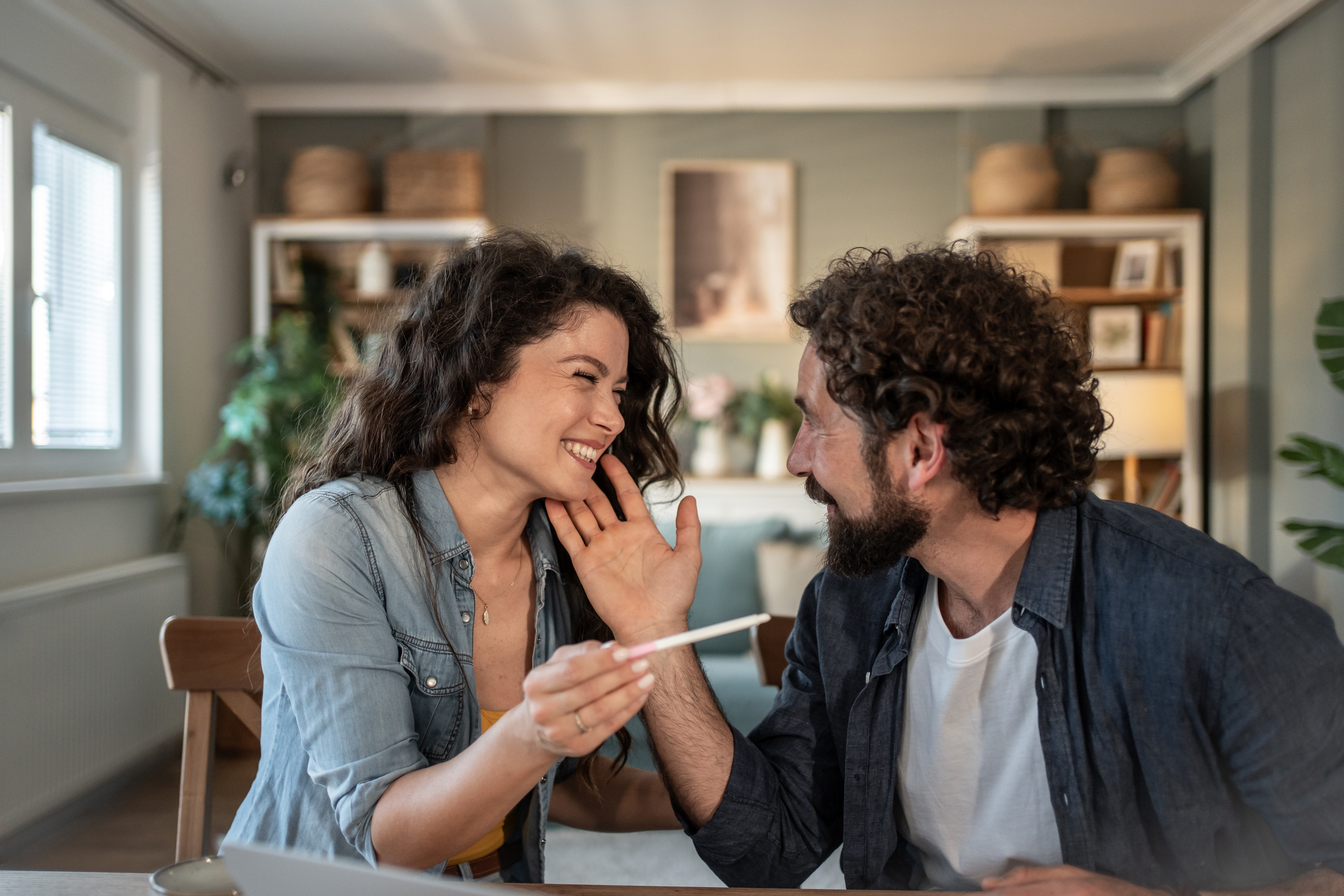 Excited,Couple,Sharing,A,Tender,Moment,At,Home,As,They